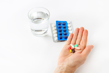 Female hand hold handful of different pills. Healthcare and medical for elder. Medicines for the treatment of diseases of old senior people. Menopause or hormonal drug for woman. Copy space for text