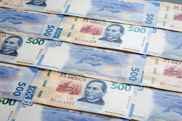 Mexican 500 pesos pile of blue bucks stack on top left close up