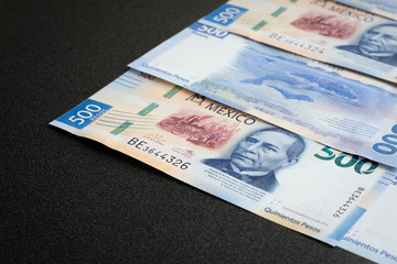 Mexican 500 pesos pile of blue bucks stack on top corner
