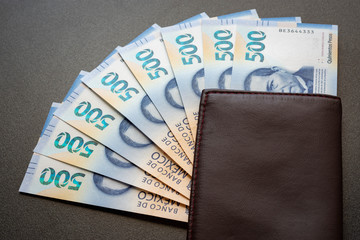 Mexican 500 pesos pile of blue bucks inside a wallet close up