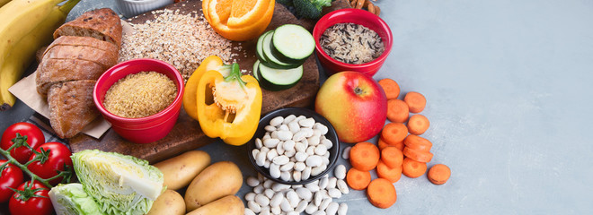 Foods high in carbohydrates on grey background