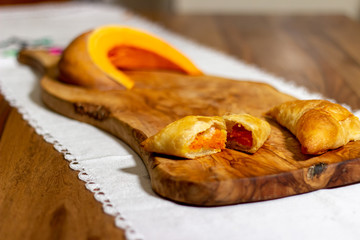 pies on a wooden cutting board with  pumpkin