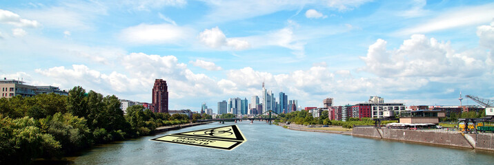 Skyline of Frankfurt, with warning sign, biohazard symbol, Pandemic COVID-19 during the at quarantine time because of coronavirus infection. corona virus outbreak, quarantine, social isolation.