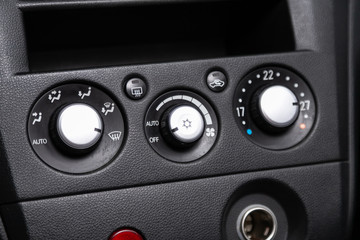 close up of  car panel with the air conditioning button inside a car..