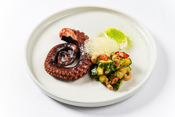  Slate of appetizing boiled octopus with vegetable garnish