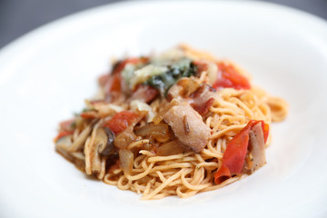 spaghetti Bolognese with minced beef and tomato sauce garnished with parmesan cheese and basil , Italian food