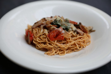 spaghetti Bolognese with minced beef and tomato sauce garnished with parmesan cheese and basil , Italian food