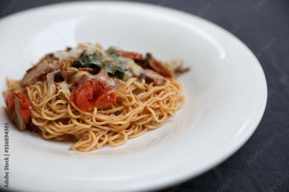 Wall mural spaghetti Bolognese with minced beef and tomato sauce garnished with parmesan cheese and basil , Italian food