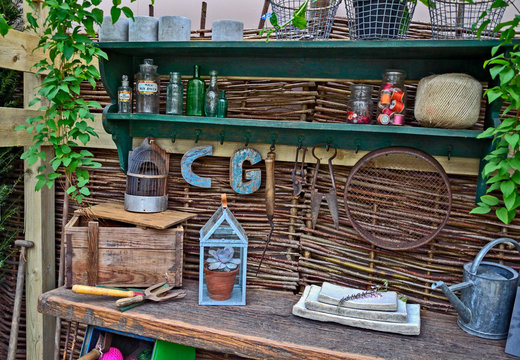 Interior of a garden potting shed with plants, tools