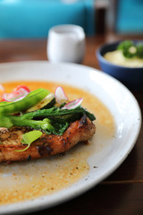 Grilled Porkchop and vegetables on top on wood background
