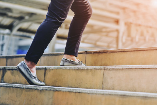 People walk up the stairs, success ideas concept with people walking to the light on street outdoor, People walking on foot in amusement park. - Powered by Adobe