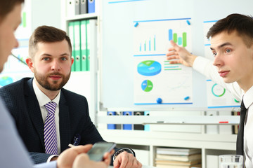 Bunch of businessmen sitting in office solving current problems portrait