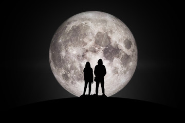 Silhouette of man and women  Looking at the moon with hope Fulfillment in love. Elements of this image furnished by NASA. - Powered by Adobe