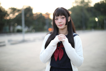 Fototapeta premium Asian school girl walking in urban city with green darden