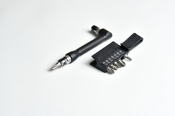Angle L-shaped screwdriver with bit set and belt clip isolated on white background. Close up