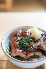 Japanese food unagi don , grilled eel on japanese rice on wood background