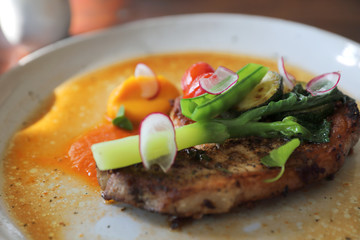 Grilled Porkchop and vegetables on top on wood background