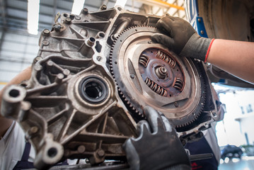 View of engine parts, engine parts and flywheel or flywheel cars Hand auto mechanic work Car repair...