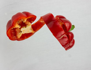 Red paprika pieces with a white background 