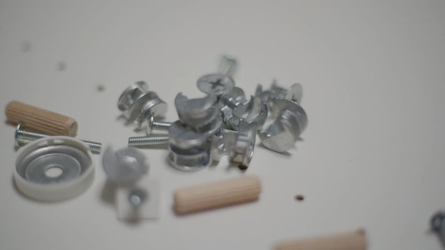 Close up men's hand puts details for furniture. Minifix Furniture