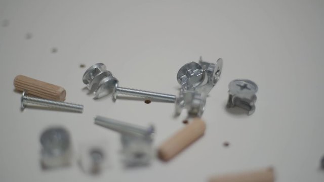 Close up men's hand picks up details for furniture