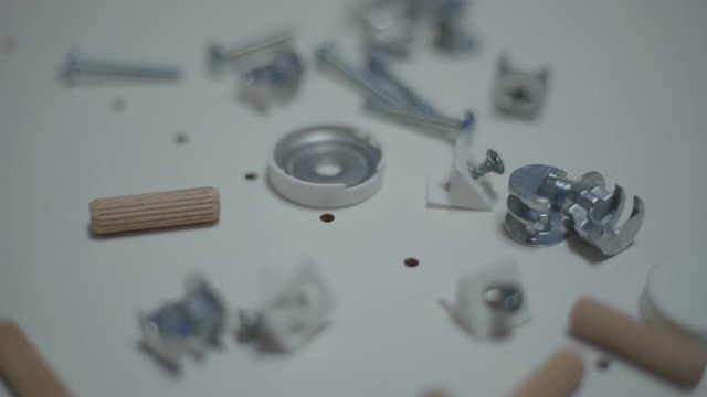 Close up men's hand puts details for furniture. Minifix Furniture