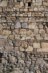 background, many stones lie on each other, a wall of stone.