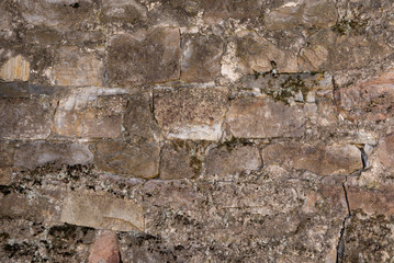 The texture of the stone wall. old wall of stone and cement.