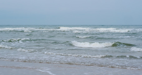 Waves break on tropical sand beach