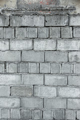 A wall of rectangular stones laid on top of each other. Texture and background.