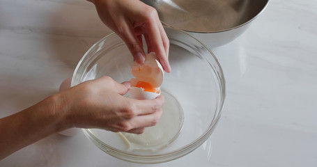 Break egg to separate egg white and yolk