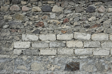 stones of different sizes and shapes lie on top of each other. cement between them. The construction of a new building.