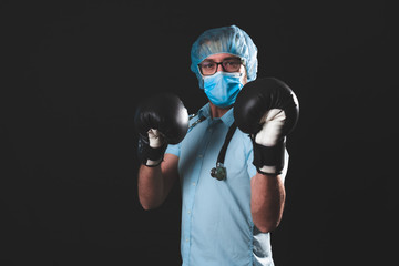 Doctor / surgeon / scientist with boxing gloves ready to fight the virus and illness.