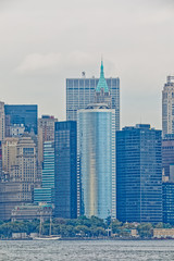 Fototapeta na wymiar Manhattan Island panorama during the gloomy weather from the Staten Island Ferry in New York.