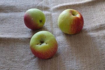 beautiful apples on a light background of burlap on the fruit, dents are visible during transportation