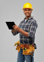profession, construction and building - happy smiling indian worker or builder in helmet with tablet pc computer over grey background