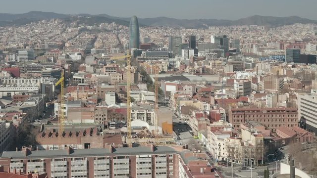 AERIAL: Barcelona Wide Drone Shot of City Towards Center with La Sagrada Familia and Torre Glories, Torre Agbar 