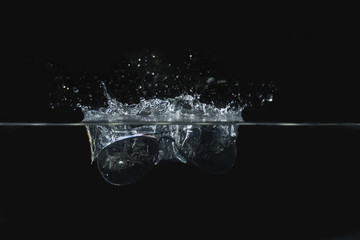 Sunglasses falling into water