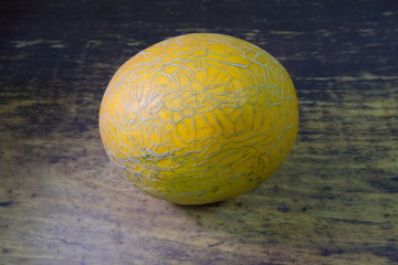 melon on a dark wooden background side view