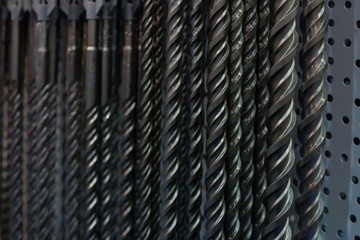 Dark background with assorted drill parts - close up photo with selective focus