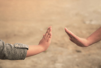 Social distancing and non-contact greetings. Two young children's hands reaching out to touch each other. Concept of public health.