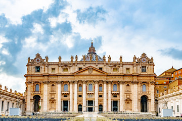 Fototapeta na wymiar Rome, Italy. Papal Basilica of Saint Peter in St Peters Square, Vatican City. Old religious Italian/ Roman architecture landmark building with statues of Saints. Famous Renaissance Church/ Cathedral.