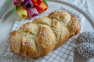 Home made sweet braided bread on a wooden board