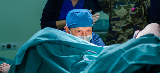 Surgeon doctor in operating room during gynecological biopsy