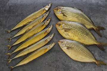 Appetizing smoked fish on kitchen board.Smoked mackerel.Smoked fish with spices
