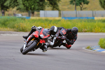 Obraz premium Motorcycle practice leaning into a fast corner on track