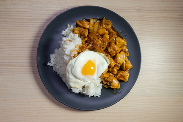 A plate of teriyaki chicken and fried egg with white rice.