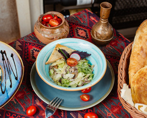 caesar salad with beef fried mushroom lettuce parmesan cherry tomato and sauce