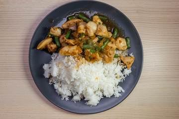 Stir fried chicken and green bean with white rice.