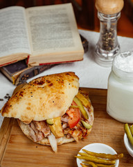 chicken doner in bread with fries pickled cucumber tomato